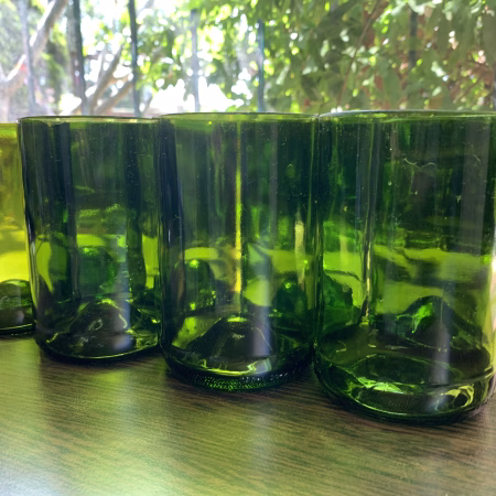 Set of four green drinking glasses made from wine bottles