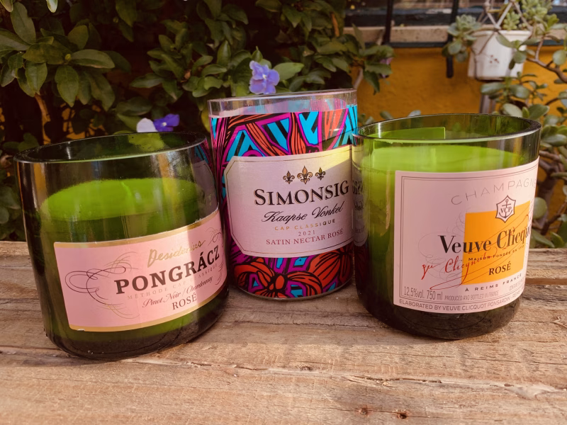 three champagne bottles turned into pot candles
