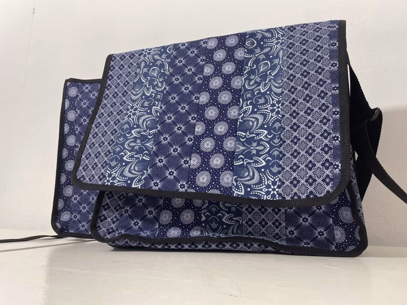 Upcycle blue and white shwe shwe and pcv vinyl meesanger bag taken from the front with no branding