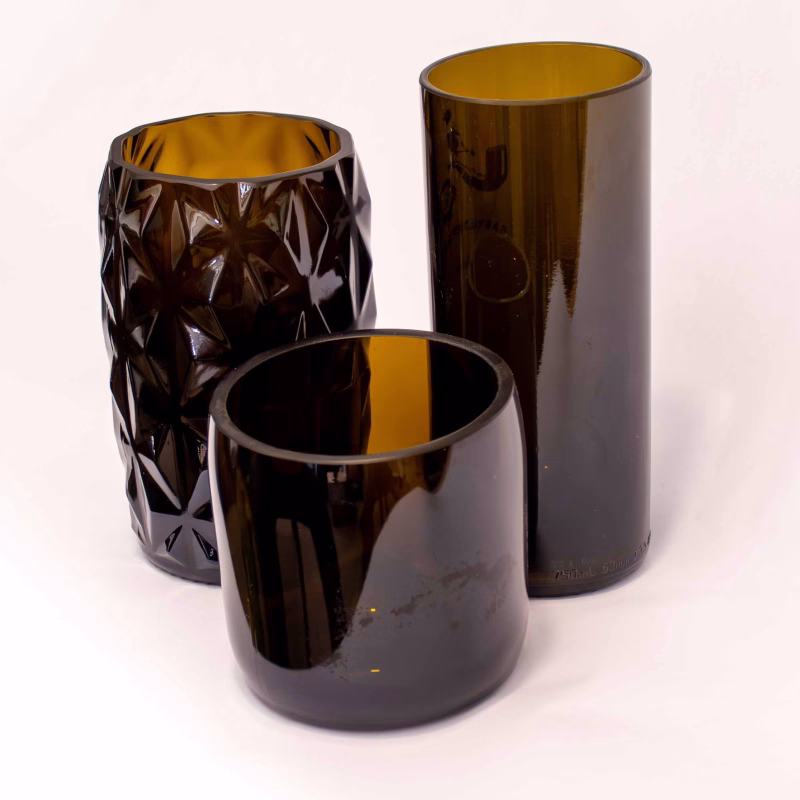 three different brown bottles cut as vases